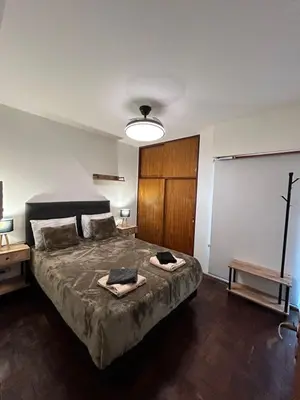 a bedroom with a large bed with a projector at Practico y tranquilo Departamento en Alberdi in Cordoba