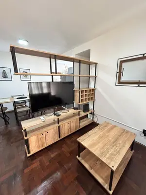 a living room with a tv and a table at Practico y tranquilo Departamento en Alberdi in Cordoba