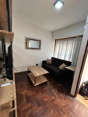 a living room with a couch and a table at Practico y tranquilo Departamento en Alberdi in Cordoba