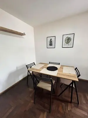 a dining room table and chairs in a room at Practico y tranquilo Departamento en Alberdi in Cordoba