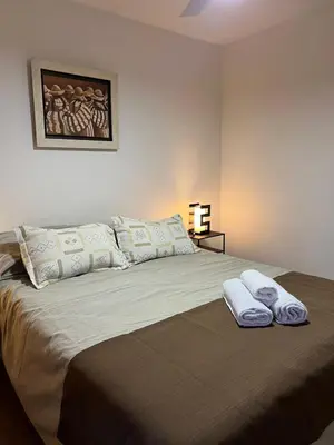 a bedroom with a large bed with two pillows at Estrada 59 Nueva Cordoba in Cordoba