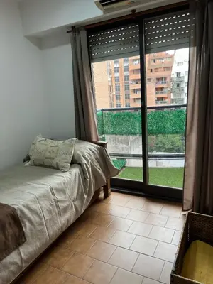 a bedroom with a bed and a large window at Estrada 59 Nueva Cordoba in Cordoba