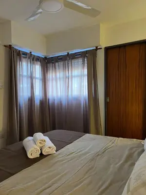 a bedroom with two towels on a bed with a window at Estrada 59 Nueva Cordoba in Cordoba