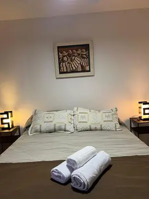 a bedroom with a bed with two towels on it at Estrada 59 Nueva Cordoba in Cordoba