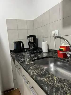 a kitchen with a sink and a counter top at Estrada 59 Nueva Cordoba in Cordoba