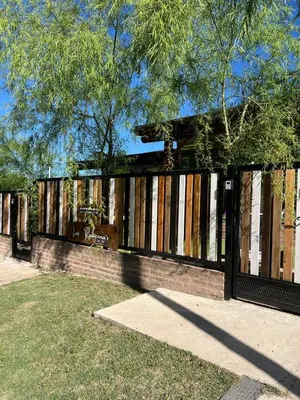 a fence with boarded up windows in a park at Casitas Rabe in Santa Rosa de Calamuchita