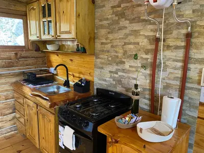 a kitchen with a stove and a sink at La retama in Alta Gracia
