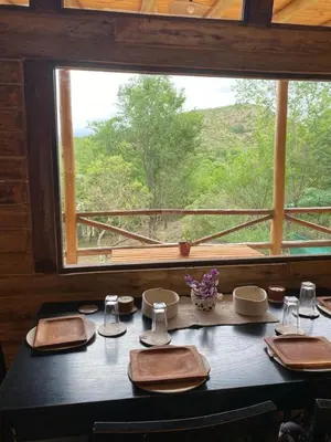 a table with a view of a window at La retama in Alta Gracia
