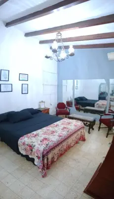a bedroom with a bed and a couch and a table at Casa centrica in Villa Carlos Paz