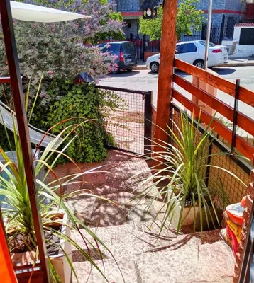 a fence with some plants next to a street at Casa centrica in Villa Carlos Paz