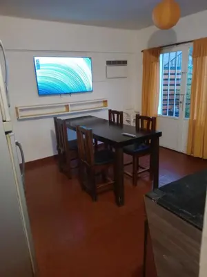 a kitchen with a dining room table and chairs at Casa centrica in Villa Carlos Paz