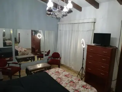 a bedroom with two beds and a dresser with a mirror at Casa centrica in Villa Carlos Paz
