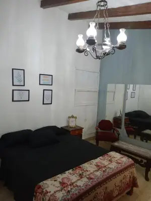 a bedroom with a bed and a chandelier at Casa centrica in Villa Carlos Paz