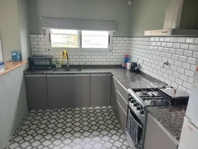 a kitchen with a sink and a stove at La Puntana 