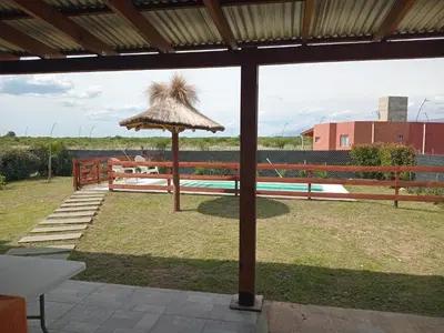 a patio with a table and an umbrella at La Puntana 