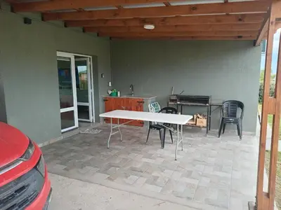 a patio with a table and chairs and a grill at La Puntana 