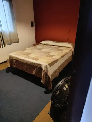 a small bedroom with a bed in a room at Alojamiento Nory's in Villa Carlos Paz