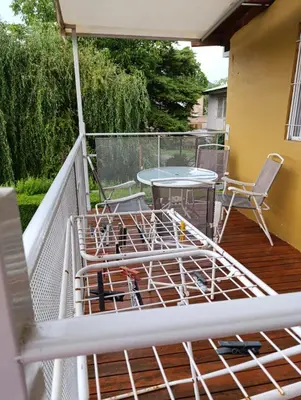 a deck with a table and chairs on a balcony at Alojamiento Nory's in Villa Carlos Paz
