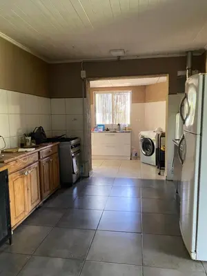 a kitchen with a refrigerator and a washer and dryer at Las estrellas in Las Tapias