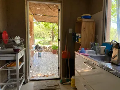 a kitchen with a door open to a yard at Las estrellas in Las Tapias