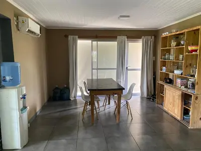 a kitchen with a table and chairs and a refrigerator at Las estrellas in Las Tapias
