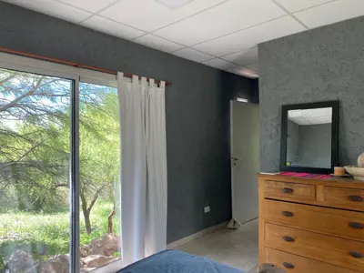 a bedroom with a mirror and a dresser and a window at Las estrellas in Las Tapias