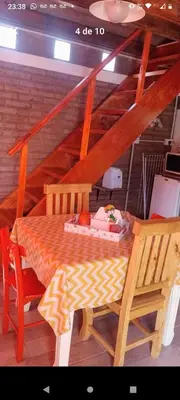 a wooden table and two chairs in a room at Cabañas El Nirvana Villa Quillinzo in Villa Quillinzo