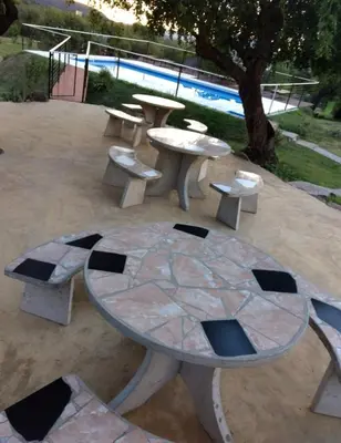 a group of picnic tables and benches next to a pool at Rincón Soñado in Las Rabonas