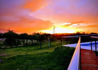 a view of a sunset from the balcony of a house at Rincón Soñado in Las Rabonas