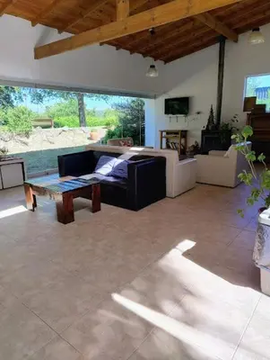 a living room with a couch and a table at Posada La Rosita - Casa in Santa Rosa de Calamuchita