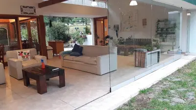 a living room with a couch and a table at Posada La Rosita - Casa in Santa Rosa de Calamuchita