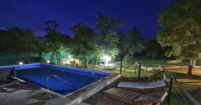 a swimming pool in a park at night at Posada La Rosita - Casa in Santa Rosa de Calamuchita