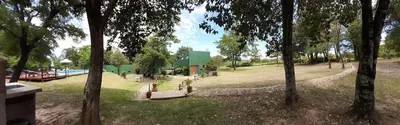 a view of a park with a pool and trees at Posada La Rosita - Casa in Santa Rosa de Calamuchita