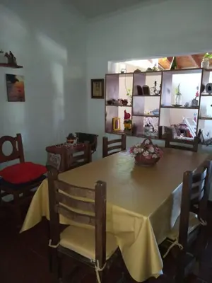 a dining room with a table and chairs with a yellow table cloth at Casa en Villa Carlos Paz in Villa Carlos Paz