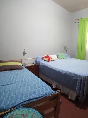 two beds sitting next to each other in a bedroom at Casa en Villa Carlos Paz in Villa Carlos Paz
