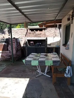 a table under awning in a patio at Casa en Villa Carlos Paz in Villa Carlos Paz