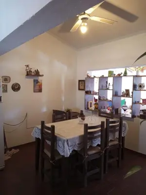 a dining room with a table and chairs at Casa en Villa Carlos Paz in Villa Carlos Paz