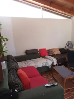 a living room with a couch and a table at Casa en Villa Carlos Paz in Villa Carlos Paz