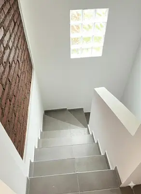 a staircase with a window and a brick wall at El Cuyanito Merlo in Merlo