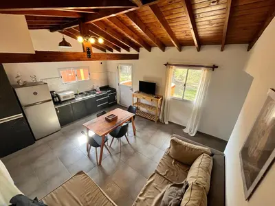 a living room with a couch and a table at El Cuyanito Merlo in Merlo