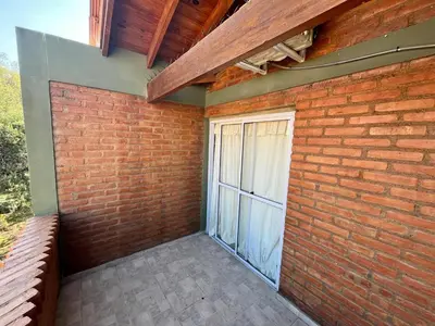a brick wall with a window and a patio at El Cuyanito Merlo in Merlo
