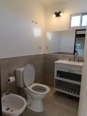 a bathroom with a toilet and a sink at El Cuyanito Merlo in Merlo