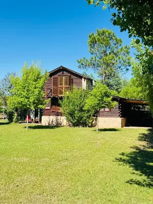a house in a field with trees and grass at Guathemoc cabañas in Panaholma