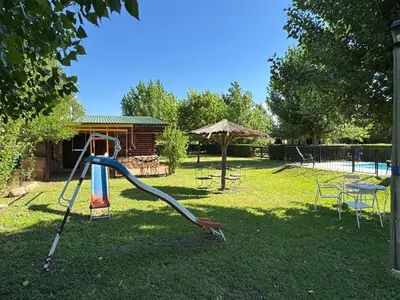 a playground in a yard with a slide at Guathemoc cabañas in Panaholma