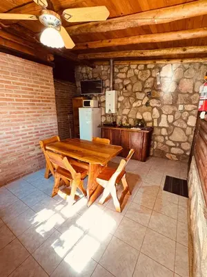 a kitchen with a wooden table and a refrigerator at Guathemoc cabañas in Panaholma
