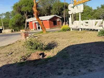 a shadow of a sign on the side of a street at Cabañas Campo y Río in San Lorenzo