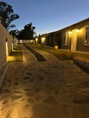 an empty street at night with a building at Los Pinos in Achiras
