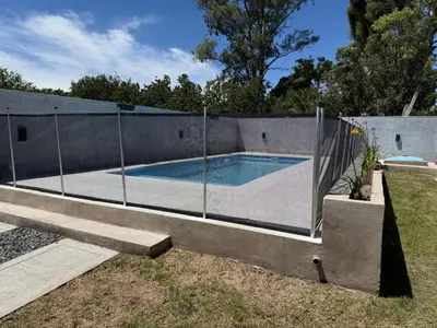 a swimming pool with a fence around it at Los Pinos in Achiras