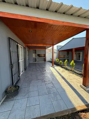 an outdoor patio with a wooden pergola at Los Pinos in Achiras