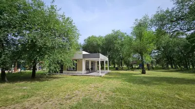 a small house in a park with trees at Complejo Ebenezer in San Ignacio